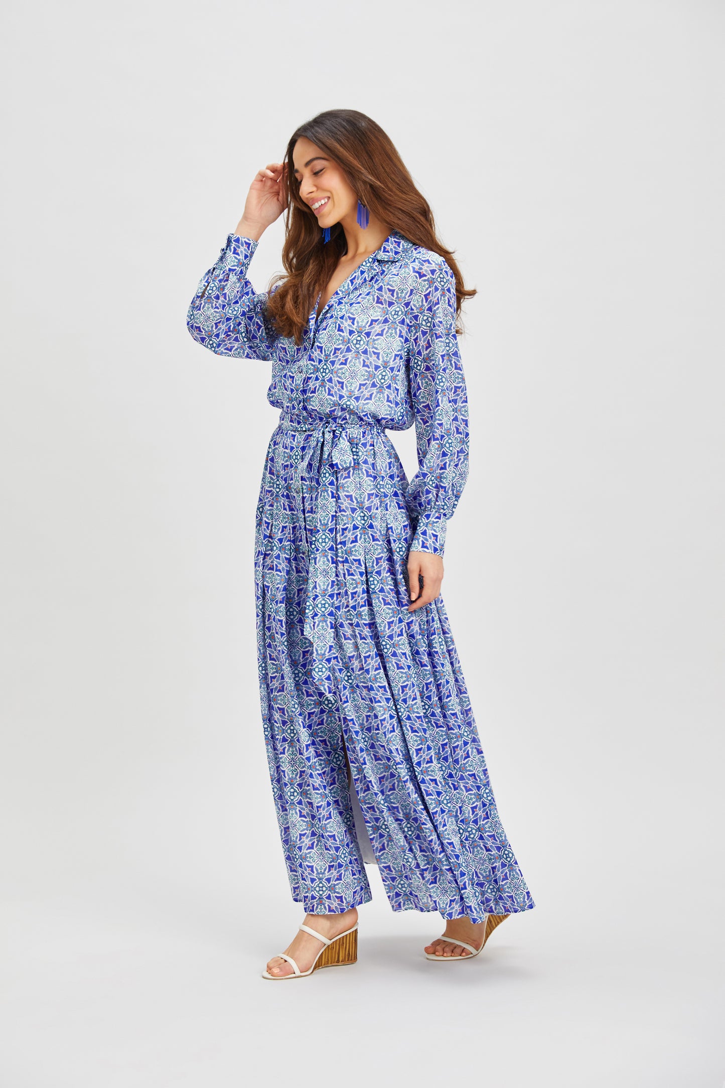 Model wearing bird-inspired silk maxi shirt dress in ultramarine tones